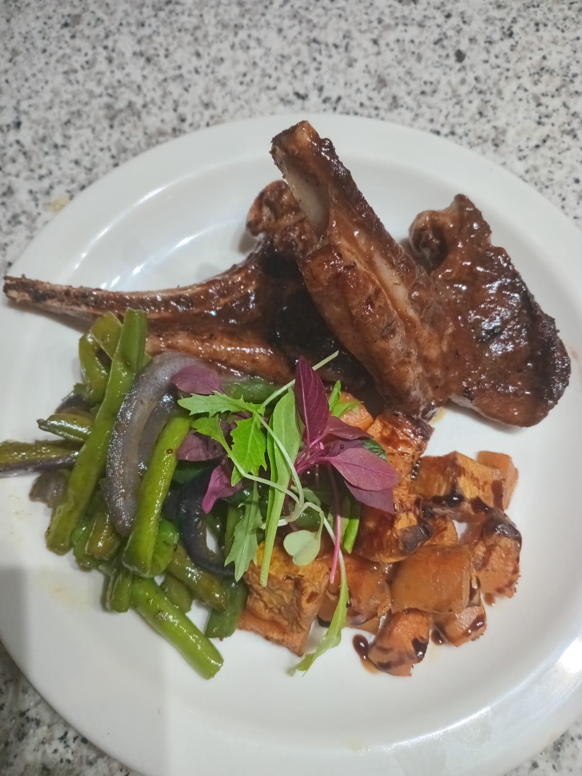 Lamb chops with asparagus, mushrooms and microgreen salad